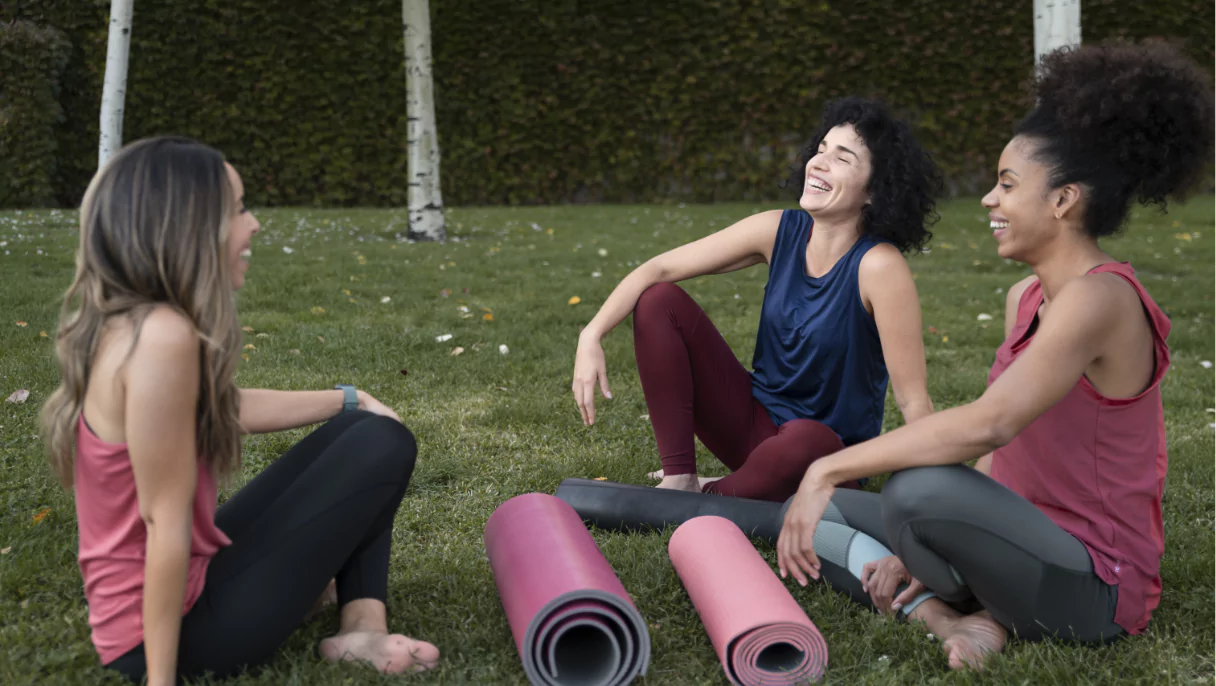 full-shot-women-sitting-grass-6757dfd270fa6